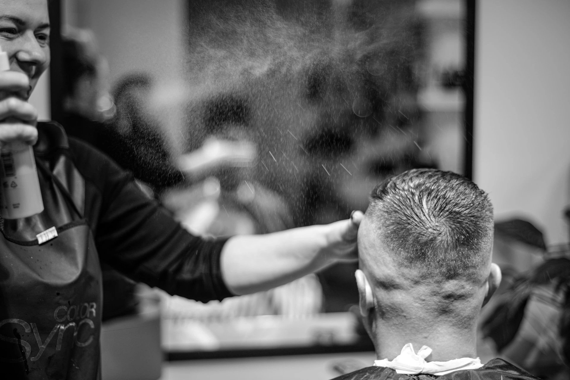 a man getting his hair cut at a barber shop