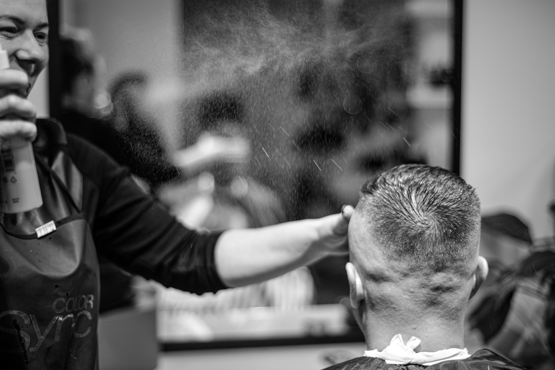 a man getting his hair cut at a barber shop