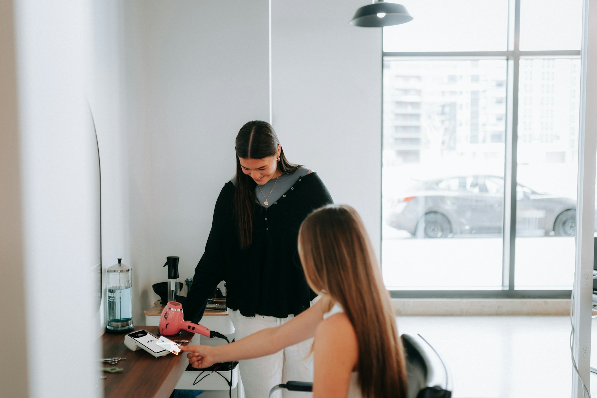 A hairstylist is working on a customer's hair.